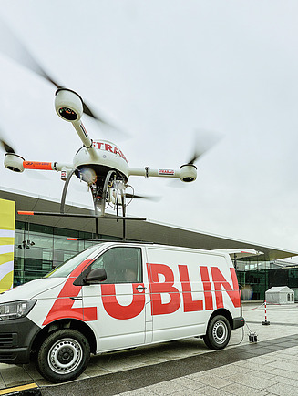 Drone hovering in front of Züblin transporter at exhibition center