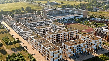 Several blocks of flats in a park-like landscape